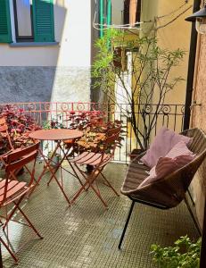 a group of chairs and tables on a balcony at Via Scale Apartments, Lake Como, Brienno in Brienno