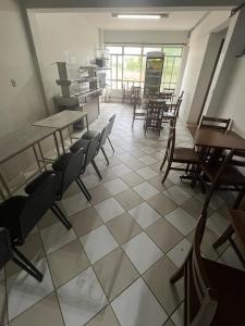 a room with tables and chairs in a restaurant at Premium Center Hotel in Betim