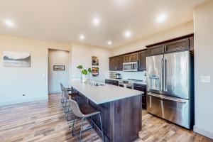 a kitchen with a large island with bar stools at Siuslaw Tides 1 in Florence