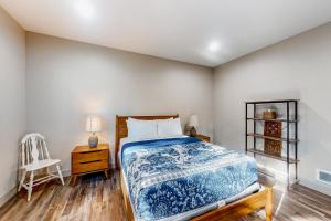 a bedroom with a bed and a chair at Siuslaw Tides 1 in Florence