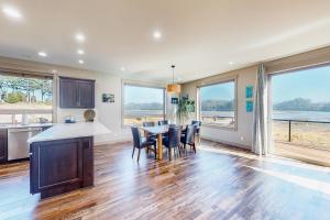 a kitchen and dining room with a table and chairs at Siuslaw Tides 2 in Florence