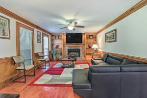 a living room with a couch and a fireplace at Pet-Friendly Lawrenceville House with Deck! in Lawrenceville