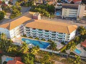 an overhead view of a building with a swimming pool at Aloha Residence in Porto De Galinhas