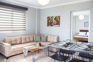 a living room with a couch and a table at Long Beach Rental Apartments in Trikomo