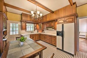 a kitchen with wooden cabinets and a white refrigerator at Lovely Reading Home with Large Yard on 7 Acres! in Reading