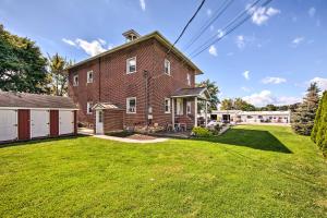 a large brick house with a grass yard at Schoolhouse Haven in Gap Communal Grill and Patio in Gap