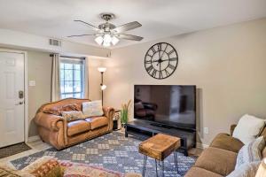 a living room with a couch and a television at Cozy Ruston Townhome Less Than 1 Mi to Louisiana Tech in Ruston