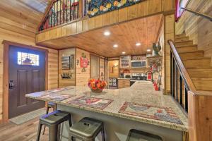 a kitchen with a large island in a log home at Cozy Tree Top Cabin about 3 Mi to Lake Hamilton in Hot Springs