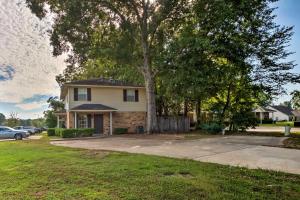 a house with a tree in front of a driveway at Cozy Ruston Townhome Less Than 1 Mi to Louisiana Tech in Ruston