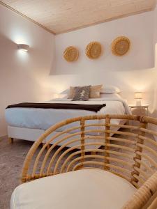 a bedroom with a bed with two mirrors on the wall at Casa Di Manto Traditional Apartment in Mýkonos City