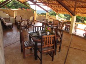 a dining room with a table and chairs in at La Case Sakalava in Ambaro