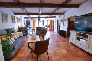 a living room with a couch and a tv at Cuencaloft La Casa Del Pintor in Cuenca