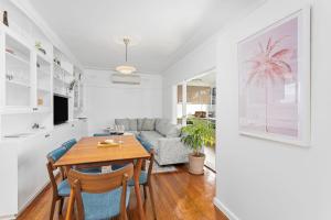 a living room with a table and a couch at The Little Lake House in Primbee