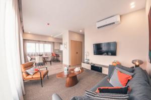 a living room with a couch and a table at Fully Serviced Apartment at Regatta Living - 3B in Santo Domingo
