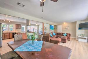 a living room with a table and a couch at Family Home with Private Pool and Fenced Yard! in Fort Walton Beach