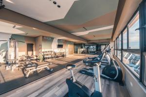 a gym with bikes and treadmills in a building at Fully Serviced Apartment at Regatta Living - 9F in Santo Domingo