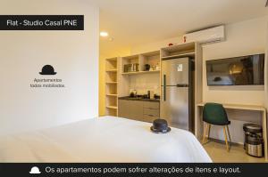 a small room with a bed and a refrigerator at Charlie Sabiá Ibirapuera in Sao Paulo