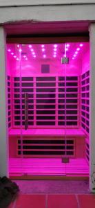 a pink room with purple lights on the inside at Vue magnifique, piscine privée chauffée et sauna à 10min de Monaco in Roquebrune-Cap-Martin