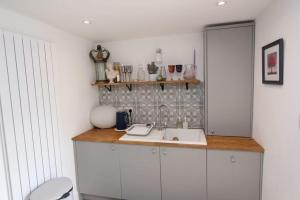 a kitchen with a sink and a counter top at Beautiful Cottage in Cowbridge in Cowbridge