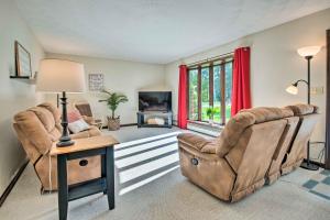 a living room with two chairs and a table at Charming Lewisburg Home with Hot Tub and Games! in Lewisburg