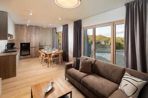 a living room with a couch and a table at Apartmán Hillside Panorama in Dolný Kubín