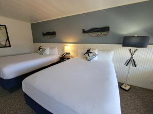 a hotel room with two beds and a lamp at Circle Hotel Fairfield in Fairfield