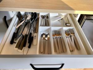 a drawer full of utensils in a cabinet at beGLAMP - Glamping nad Zalewem Próba in Brzeźnio