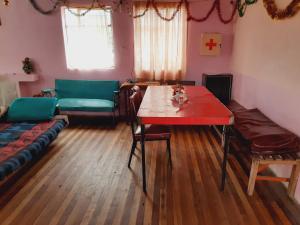 a living room with a table and a couch at Hospedaje Chimborazo in Chimborazo