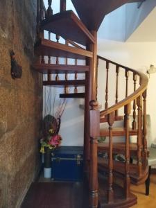 una escalera de caracol en una casa con un jarrón de flores en Alojamento Local Ferros - Duplex, en Viana do Castelo