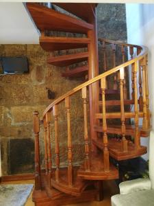 a wooden spiral staircase in a house at Alojamento Local Ferros - Duplex in Viana do Castelo