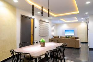 a dining room with a table and chairs and a couch at Jotani Living in Lagos