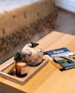 uma mesa com uma abóbora, uma vela e um livro em Korte Apartment 1 em Arta