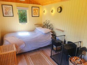 a small bedroom with a bed and a window at Safari Cornwall in Bodmin