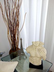 a statue on a glass table with the eiffel tower at Ocean Palms - 1Bed 1Bth King Suite Condo in Cabarete