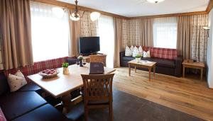 a living room with a table and a couch at Brixnerhof im Zillertal in Schlitters