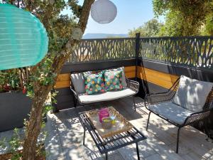 a patio with two chairs and a coffee table at gite A L' ÉVIDENCE in Mornas