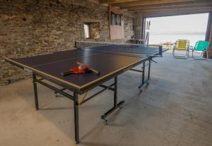 a ping pong table in a room with at The Steading in Stromness