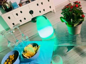 a glass table with a bowl of fruit and a plant at Blue House Mallorca in Ses Salines