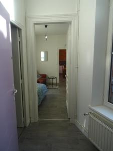 un couloir menant à une chambre avec un lit dans l'établissement Charmant studio en centre-ville, à Boulogne-sur-Mer