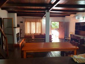 a living room with a wooden table and a couch at Casa Doña Isabel in Puerto Iguazú