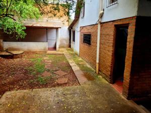 an alley with a brick building and a garage at Casa Doña Isabel in Puerto Iguazú
