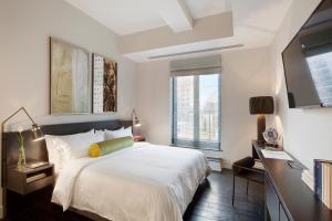 a bedroom with a large white bed and a window at The Marmara Park Avenue in New York