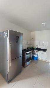 a kitchen with a stainless steel refrigerator and a stove at Dream House in Itacimirim