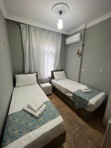 Postel nebo postele na pokoji v ubytování GRAND Deniz Hotel