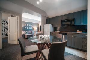 a kitchen with a table and chairs and a couch at Summit Lodge Boutique Hotel Whistler in Whistler