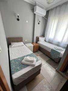Postel nebo postele na pokoji v ubytování GRAND Deniz Hotel