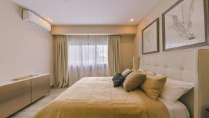 a bedroom with a large bed with pillows on it at Fully Serviced Apartment at Regatta Living II - 907 in Santo Domingo +22 photos