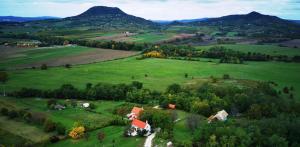 an aerial view of a green field with mountains at BaLOVEon Birtok in Káptalantóti
