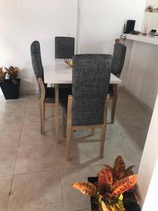 a dining room table with three chairs and a table at Donde Bris in Ríohacha