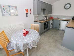 a kitchen with a table and chairs and a kitchen with a table and chairsktop at Bay View Farmhouse in Haverfordwest +18 photos